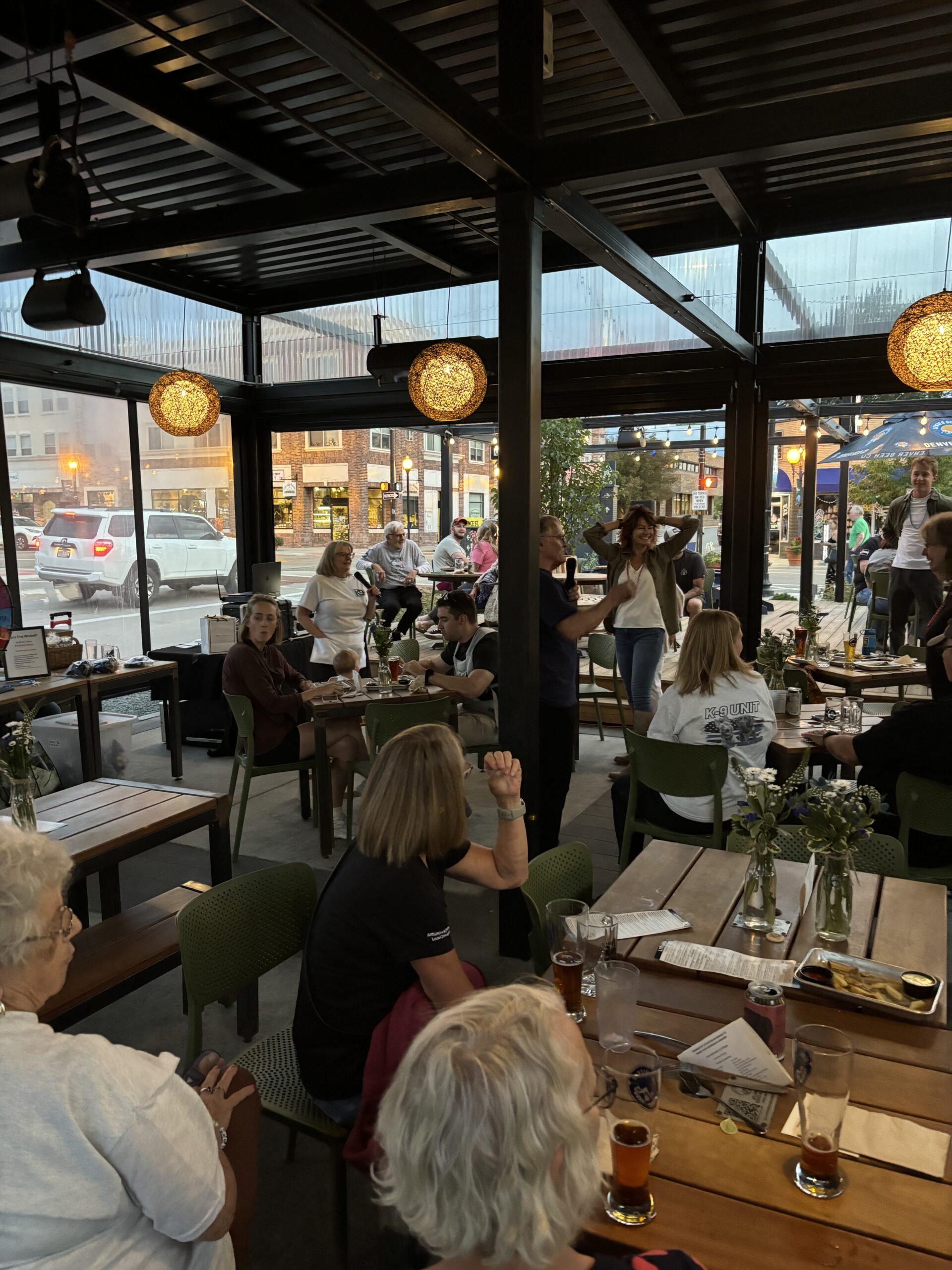 Cozy restaurant filled with diners enjoying a lively evening meal.