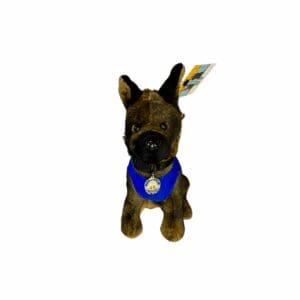 A small dog wearing a blue bandana looks up attentively.