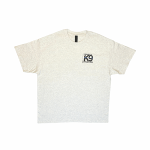 Beige t-shirt with a small black logo on the chest pocket area.
