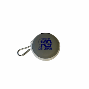 Round grey portable speaker with a carabiner clip and blue logo.